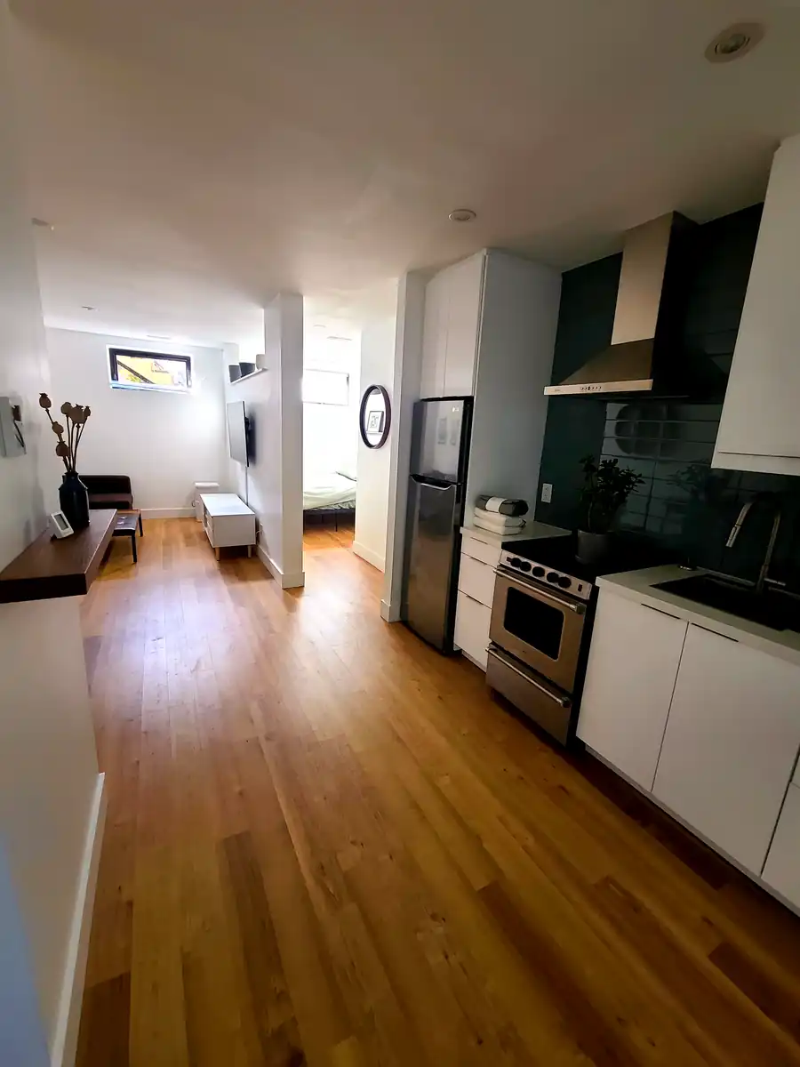 A finished basement apartment kitchen, cabinets and countertop installed